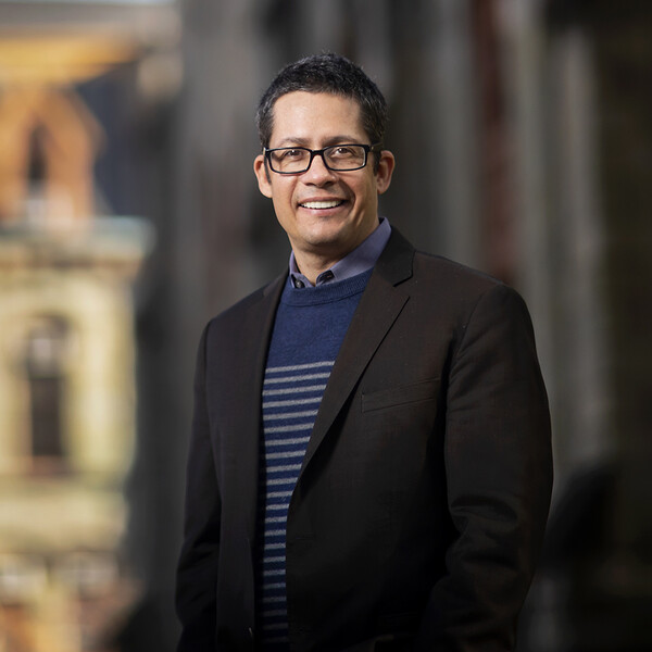 roberto gonzales in front of college hall